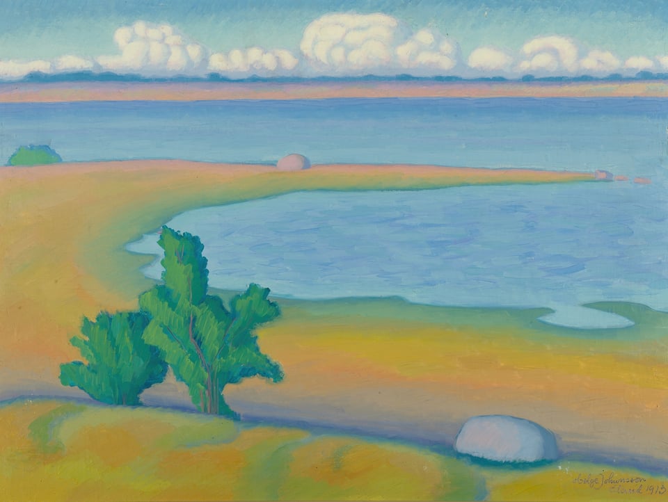 Yellow sandy beach and deep blue sea under a cloudy sky