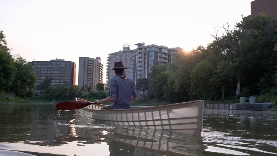 Paddling up Winnipeg's Assiniboine River in a canoe