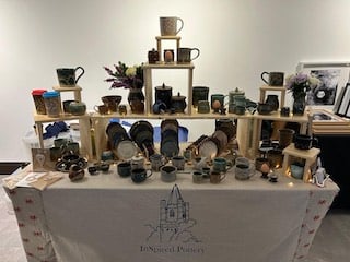 A tiered display of pottery.