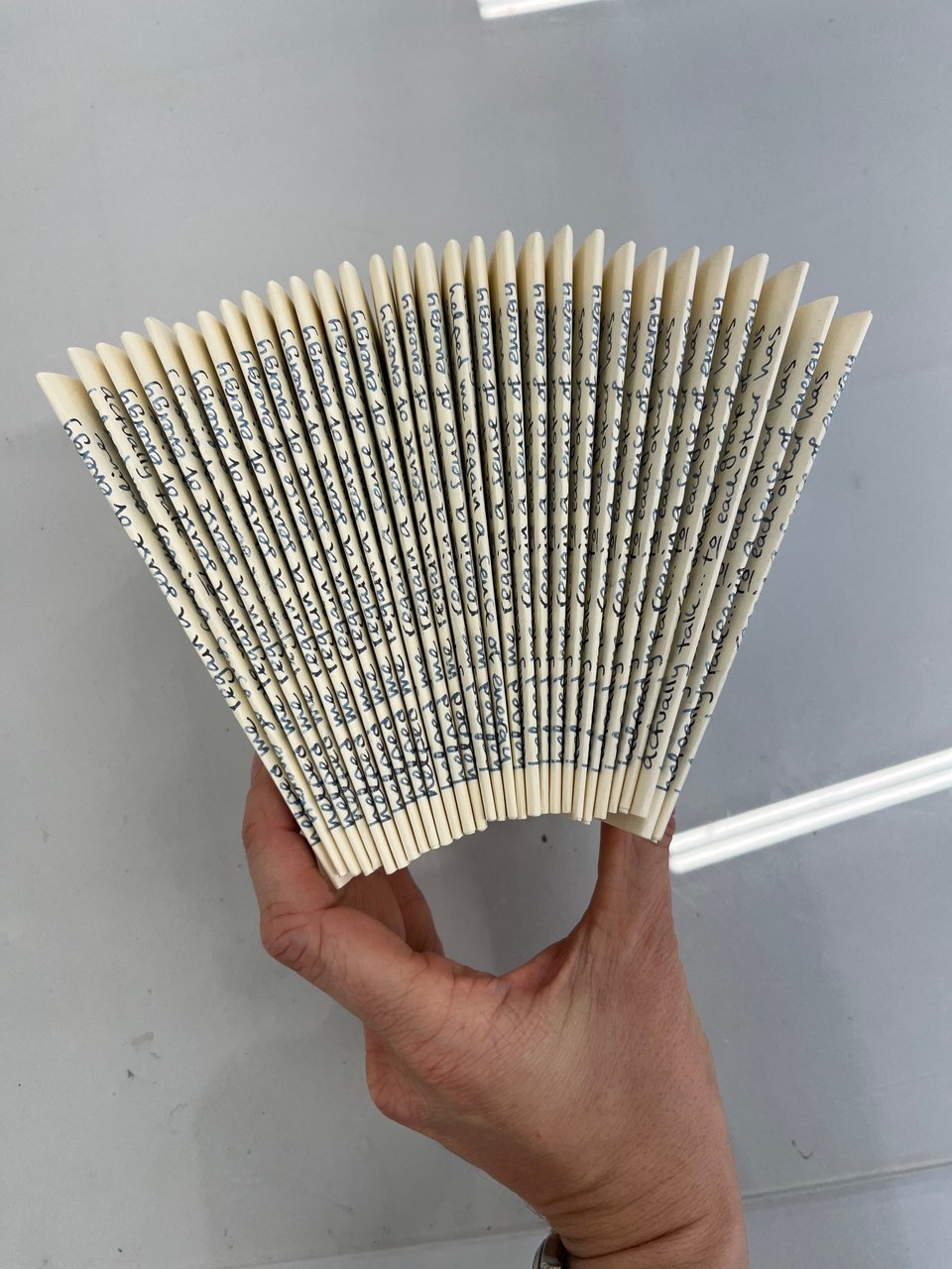 Lucy holding a fan of folded letters awaiting envelopes.