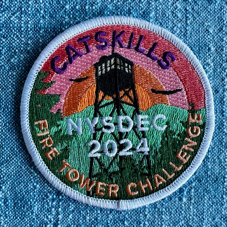 photo of multicolored patch celebrating completion of the 2024 Catskills Fire Tower Challenge