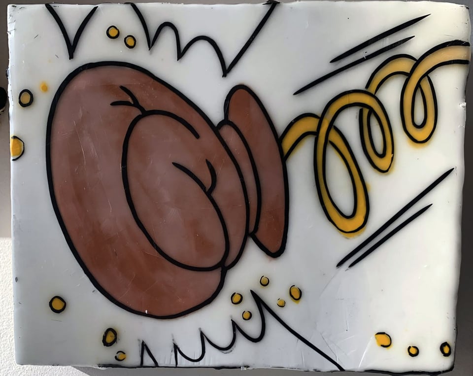 Wee painting of a cartoon boxing glove on a spring.