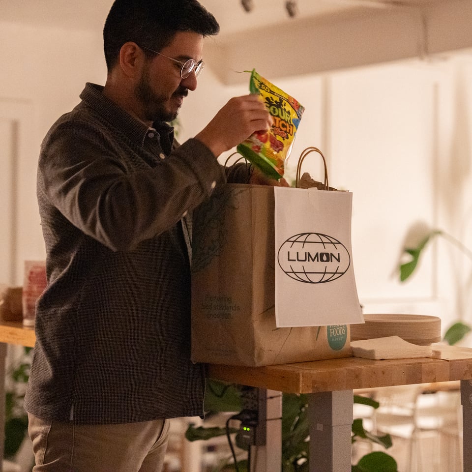 Justin setting snacks in a bag.