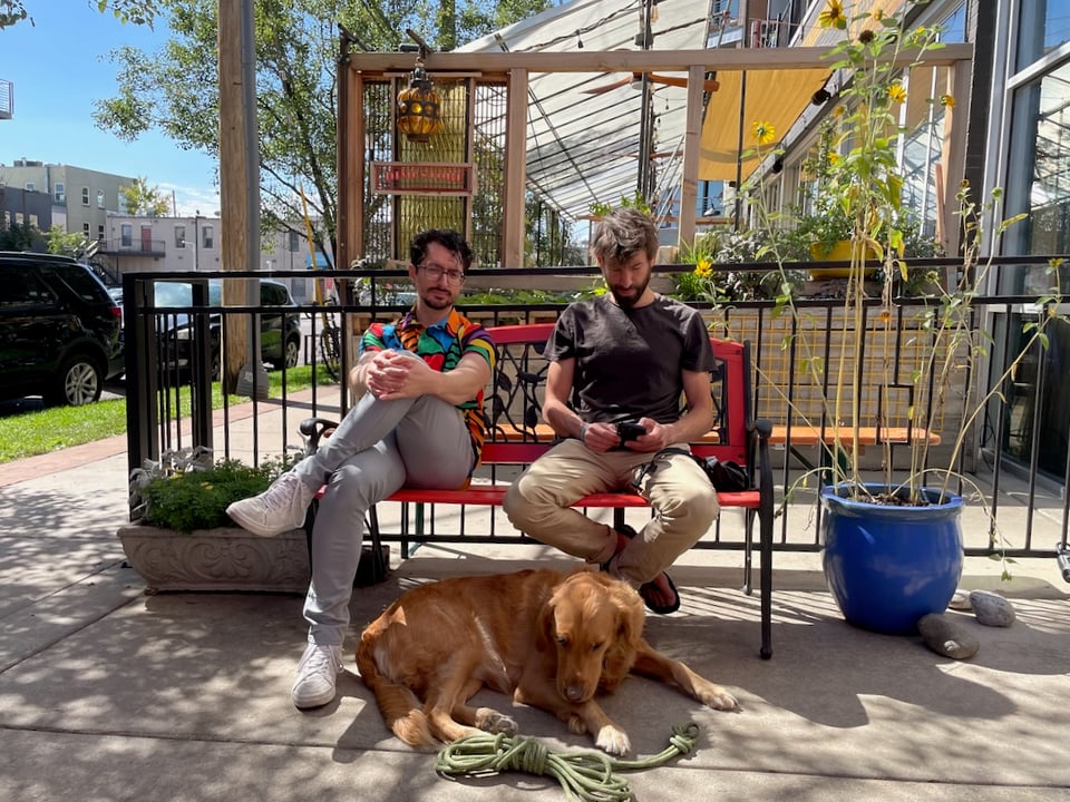 Ivan and Drew and River sitting on a bench.