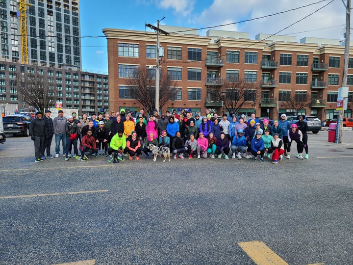 A group of runners in a parking lot in Fells Point, Baltimore