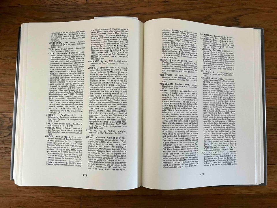 An open book with encyclopedia entries in two columns on each page.