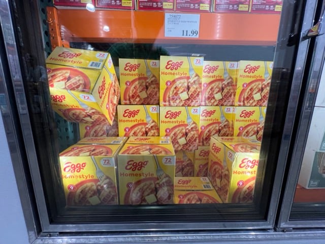 Large boxes of Eggo waffles in a freezer
