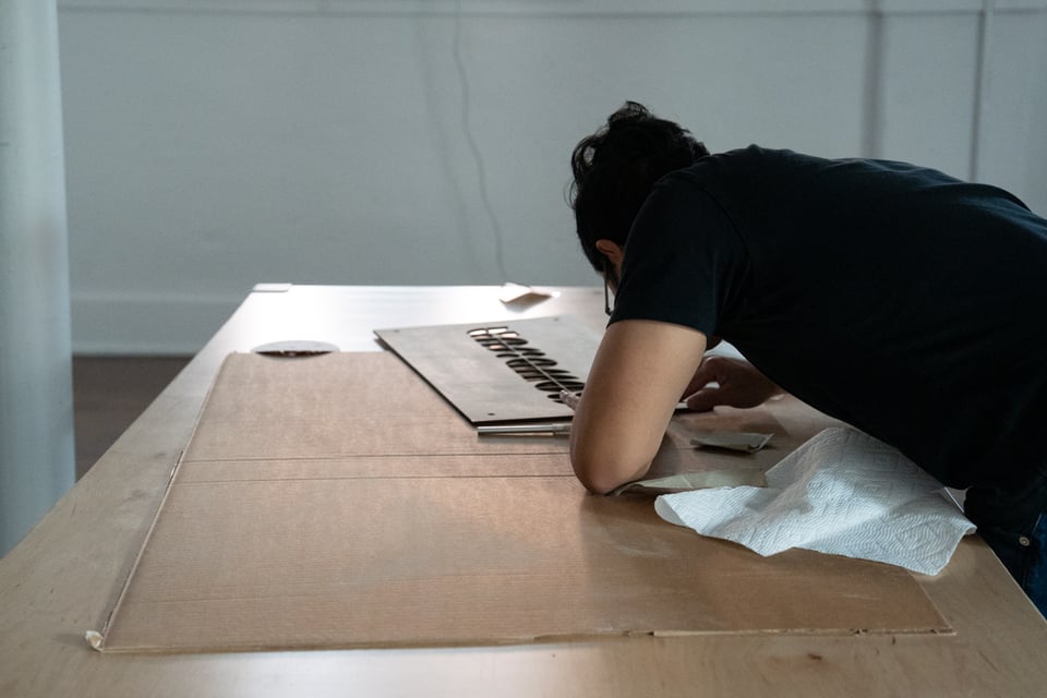 A man finishing a sign.