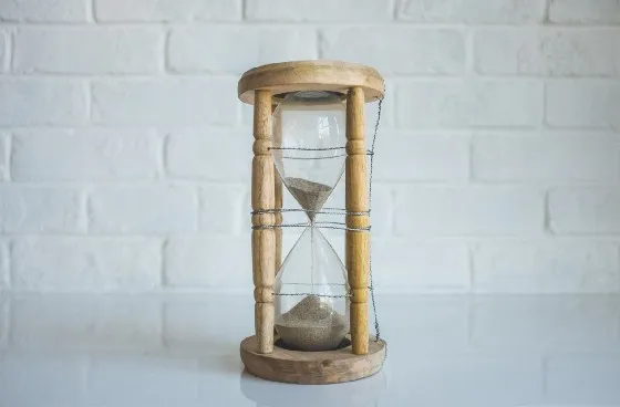 a wooden hourglass with sand in it