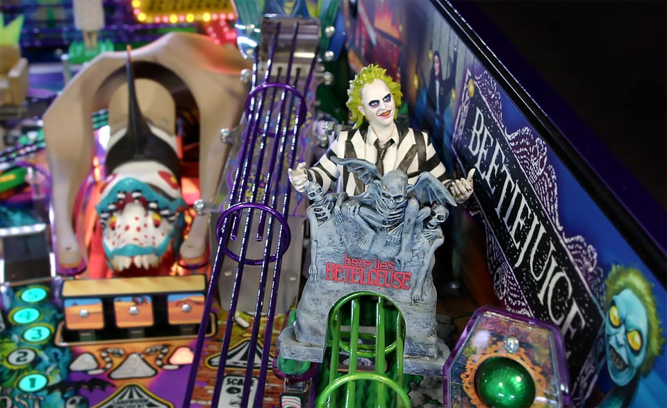 Image of parts of the playfield of the pinball machine "Beetlejuice", featuring ramp elements and a Beetlejuice character.