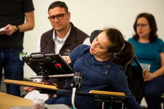 Clarity UI engineer Matt Hippely works with Stephanie Faso via an AAC (Augmentive and Alternative Communications) device to improve operation of the Clarity Design System for switch users. Photo by Jeffrey Kuo.