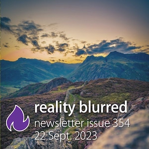 A sunrise over low mountains covered with green grass; a stone wall winding through green and purple fields; the words 'reality blurred: newsletter issue 354, 22 Sept. 2023'