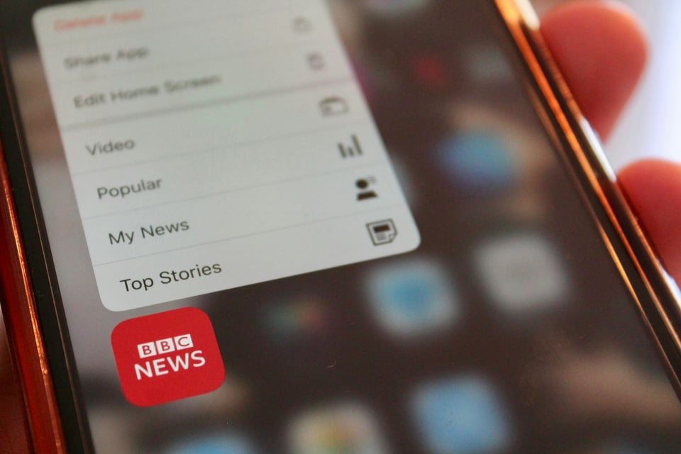 A close-up of a phone displaying the BBC News icon. Photo by Rich Smith on Unsplash