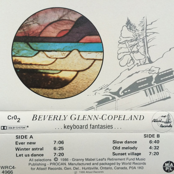 A creme colored cassette sleeve is laid flat revealing an album cover, track listing, and publishing information. A circular image of stained-glass hovers near a faded imprint of an abstractly drawn tree and a keyboard. The weight of the text on the sleeve transitions from italic to bold to regular.