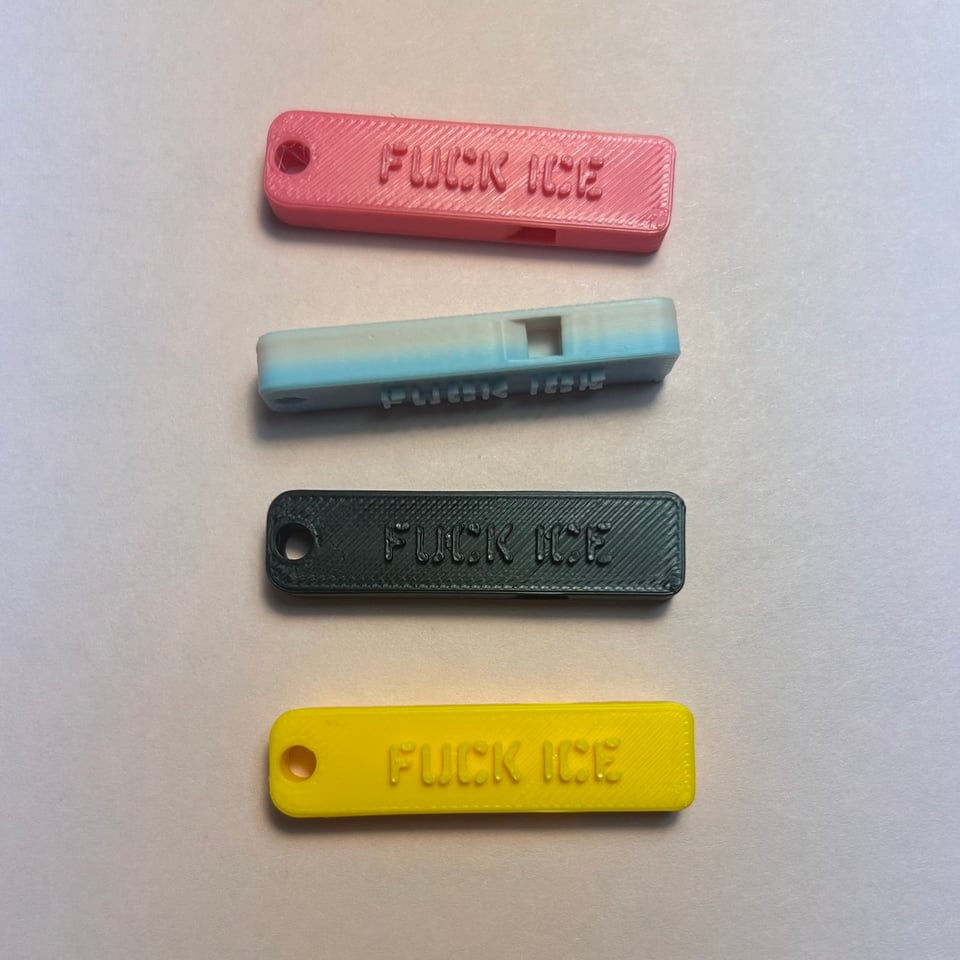 Four 3d printed whistles in various colors, hot pink, black, yellow, and a trans flag gradient that Bambu calls "cotton candy". They all say FUCK ICE.