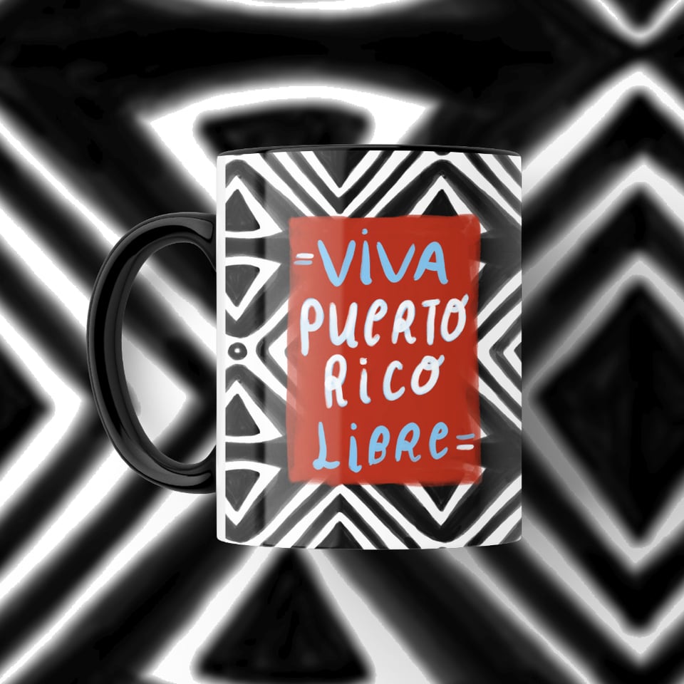 Illustration of a a black and white geometric Taino pattern on a black ceramic mug. Handwritten text reads "Viva Puerto Rico Libre". On a colorful blurred background.