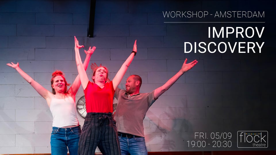 happy actors on stage with their hands lifted in the air