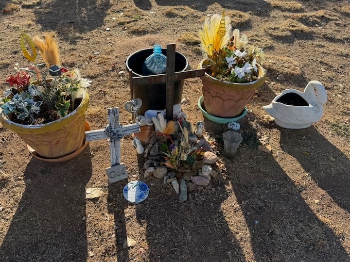 a wooden cross, a white cross, 3 flower pots, artificial flowers, and a small white swan pot