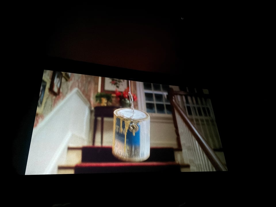 A paint can swings down the stairs