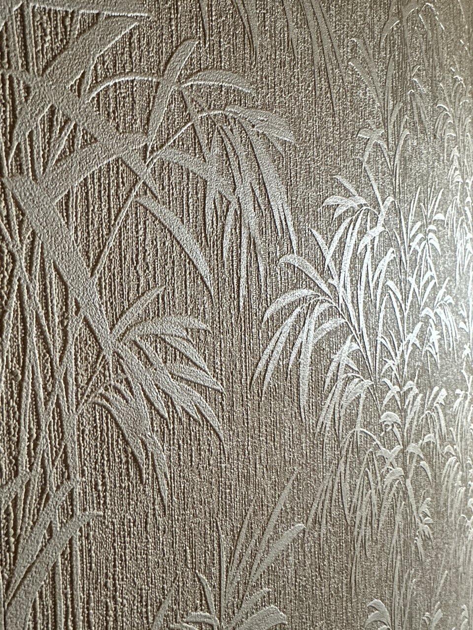Photo of wallpaper that's textured to look like bamboo leaves