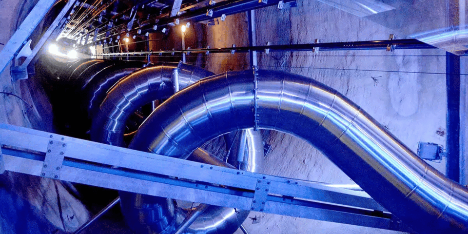 A giant slide spiraling down the middle of a mountain.