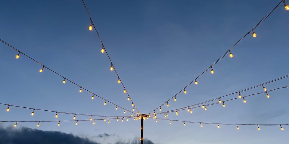 Strands of light tied to a single post.