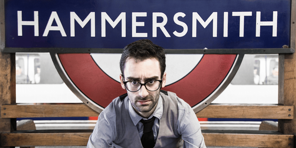 MC Hammersmith in front of a sign that says Hammersmith.