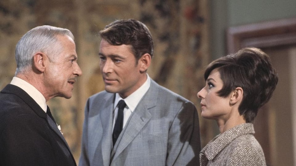 Audrey Hepburn and Peter O'Tool, side by side in a scene of the movie.