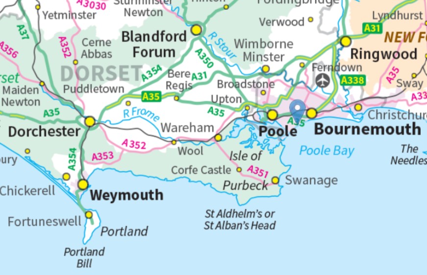 A modern OS map showing Dorset and Hampshire with Poole and Bournemouth in the eastern half. The map pin from before is in the same place. A faint grey line encircles Poole, Bournemouth and Christchurch, indicating the council boundary.