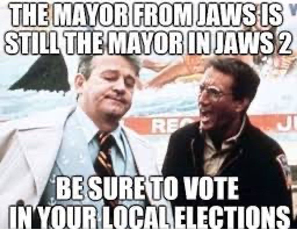 Scene from JAWS of Brodie yelling at the mayor to close the beach. Text over the image says "The mayor from JAWS is still the mayor in JAWS 2. BE SURE TO VOTE IN YOUR LOCAL ELECTIONS"