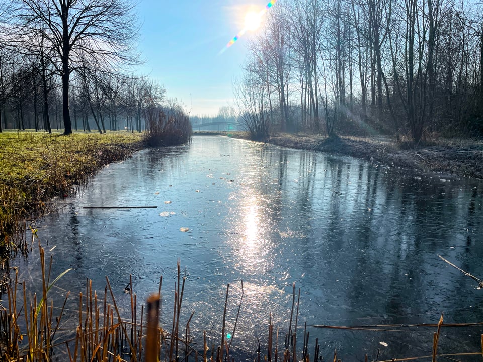 Frozen canal in MaximaPark with beautiful crisp blue sky