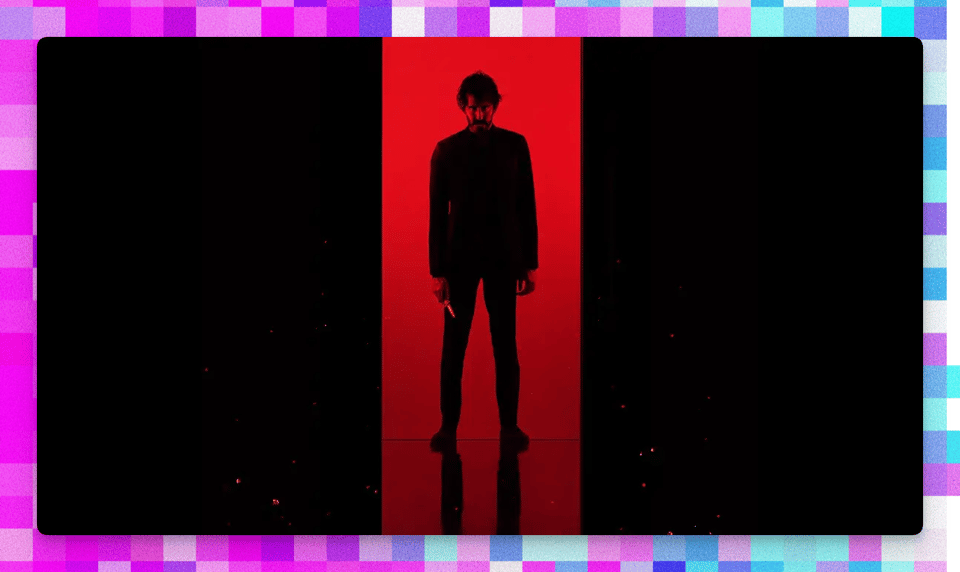 a man standing in front of a red light