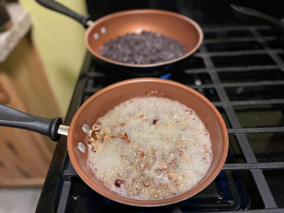 A pan bubbling with butter and nuts