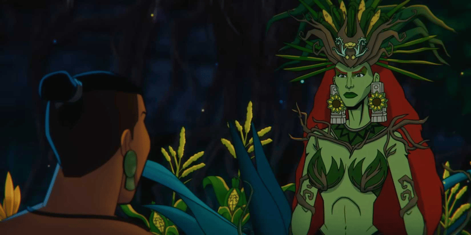 A still frame from Aztec Batman: Clash of Empires. Our hero Yohualli Coatl has his back to the camera, so all we see his close-cropped hair, which is allowed to grow longer on top and is tied into a top knot at the back, big stone earrings, and the string of his necklace. The focus of the frame is instead this film's version of Poison Ivy, a green-skinned red-haired woman wearing a crown decorated in bark and what looks like various parts of maize, two large earrings built around flowers, a green neckpiece that has vine-ish wood growing out of it, elbow bands made out of twisted branches, and, most prominently, two individual cups of green leaves with more twisty wood for underwires doing the heroic work of pushing, lifting and separating.
Also, she's extremely small-waisted.