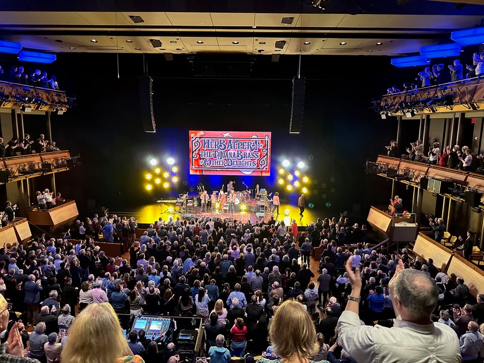 Herb Alpert and Tijuana Brass on stage with large audience