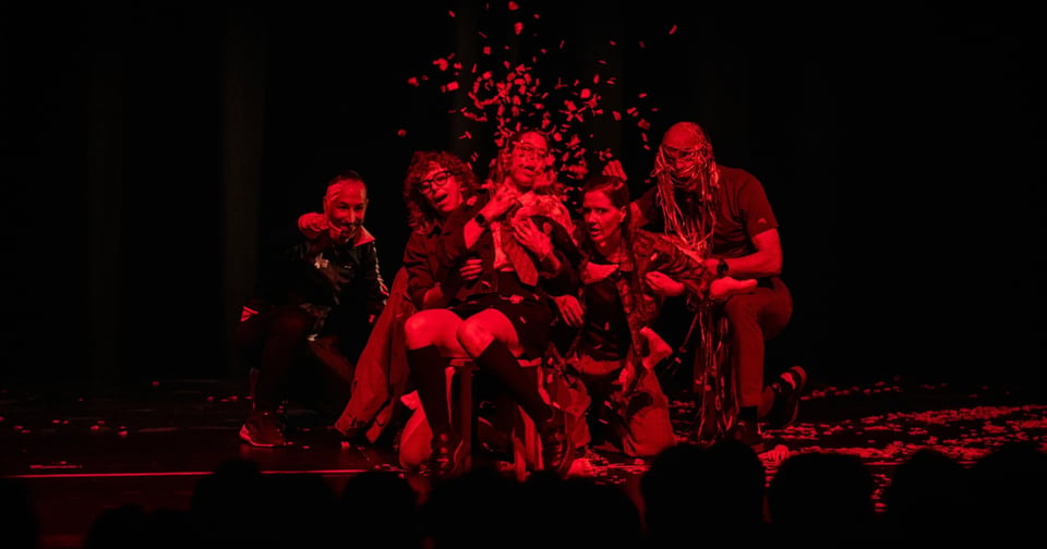 An explosive moment on stage with red confetti flying.