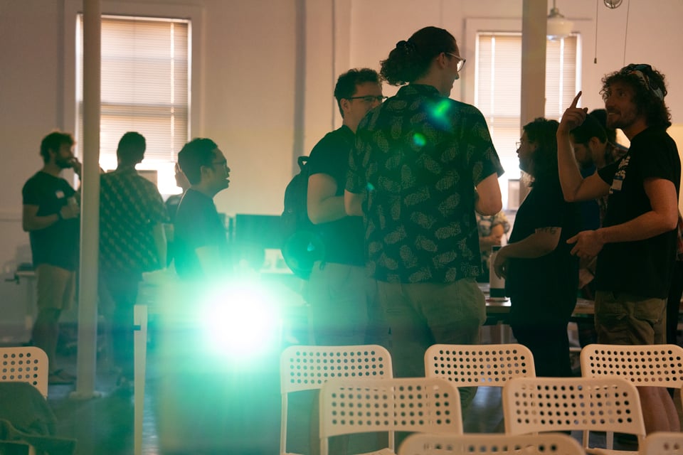 A bunch of people in a room talking to each other.