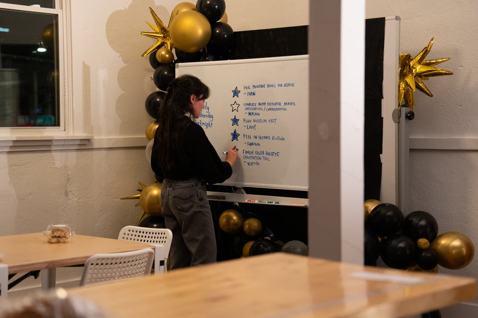 Livvy filling in a star on a whiteboard.