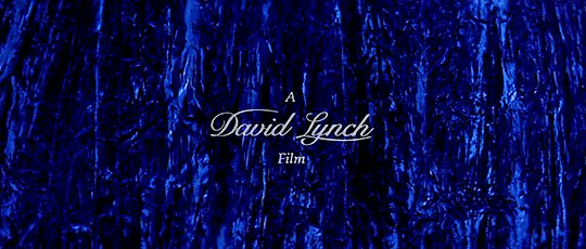 "A David Lynch Film" opening credit from the movie Blue Velvet, over some undulating blue velvet