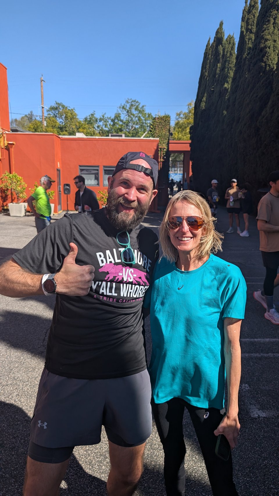Myself and Deena Kastor after the shakeout run. I'm wearing a Baltimore vs. Y'all Whores shirt.