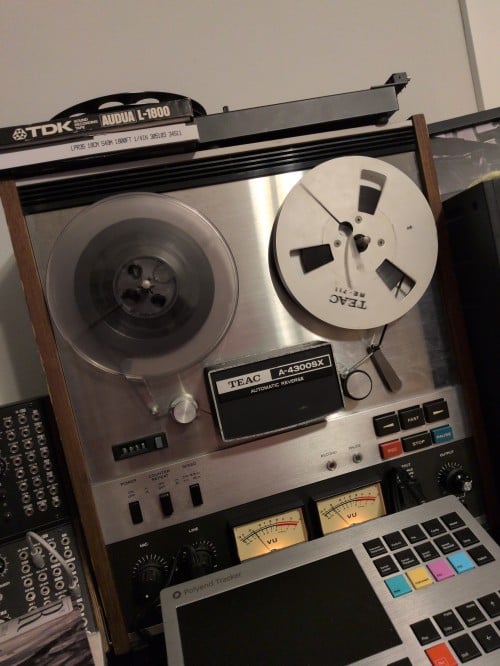 an image of several pieces of audio production equipment, in particular a large vintage TEAC tape player