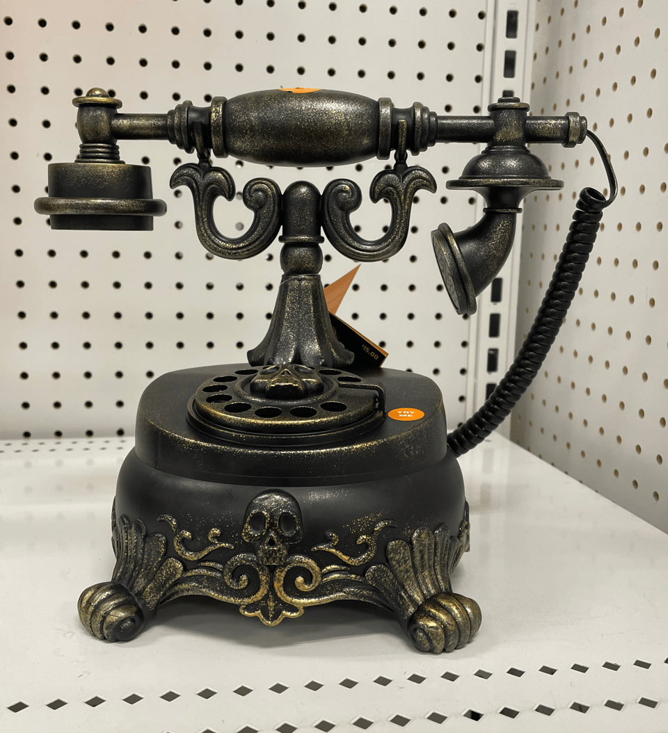 A sppoky toy of an old school landline phone from the early 20th Century