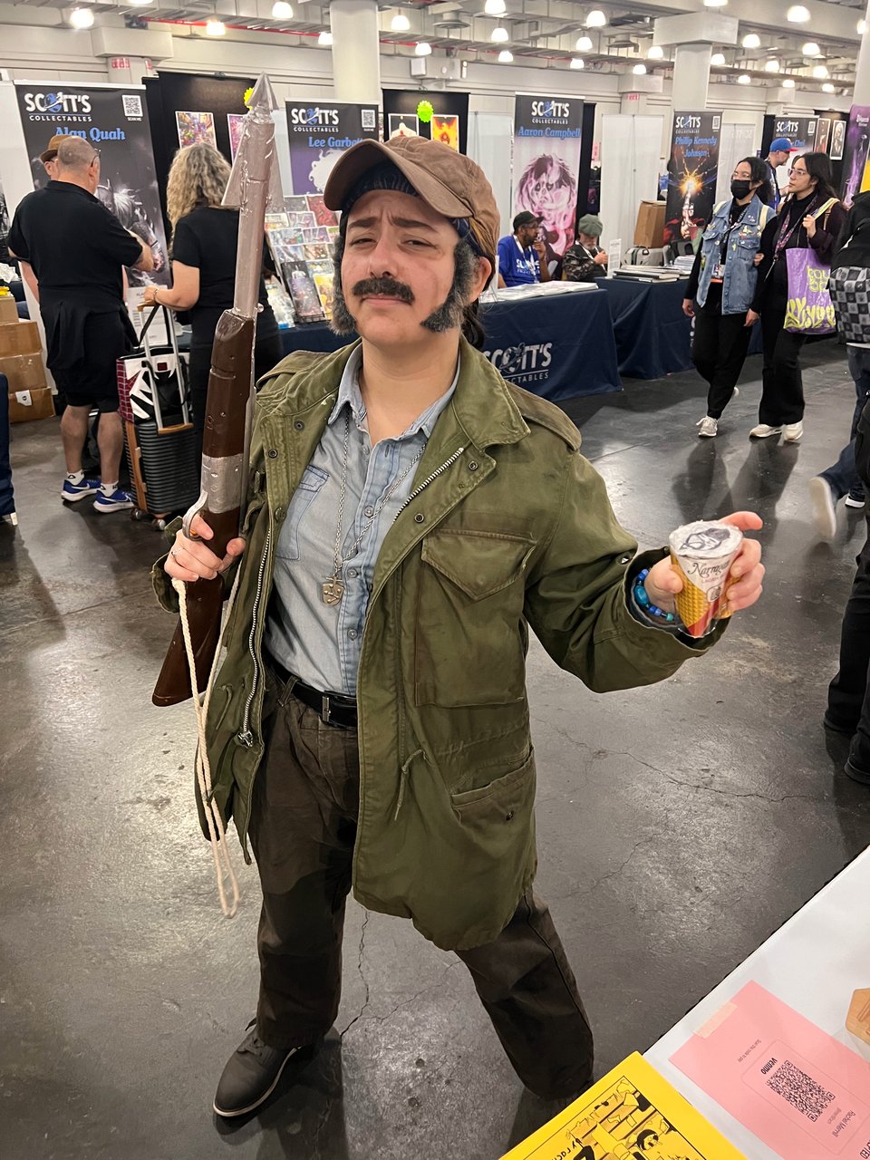 Someone cosplaying as Robert Shaw in Jaws (1975). They have a can of the beer they drink in the movie.