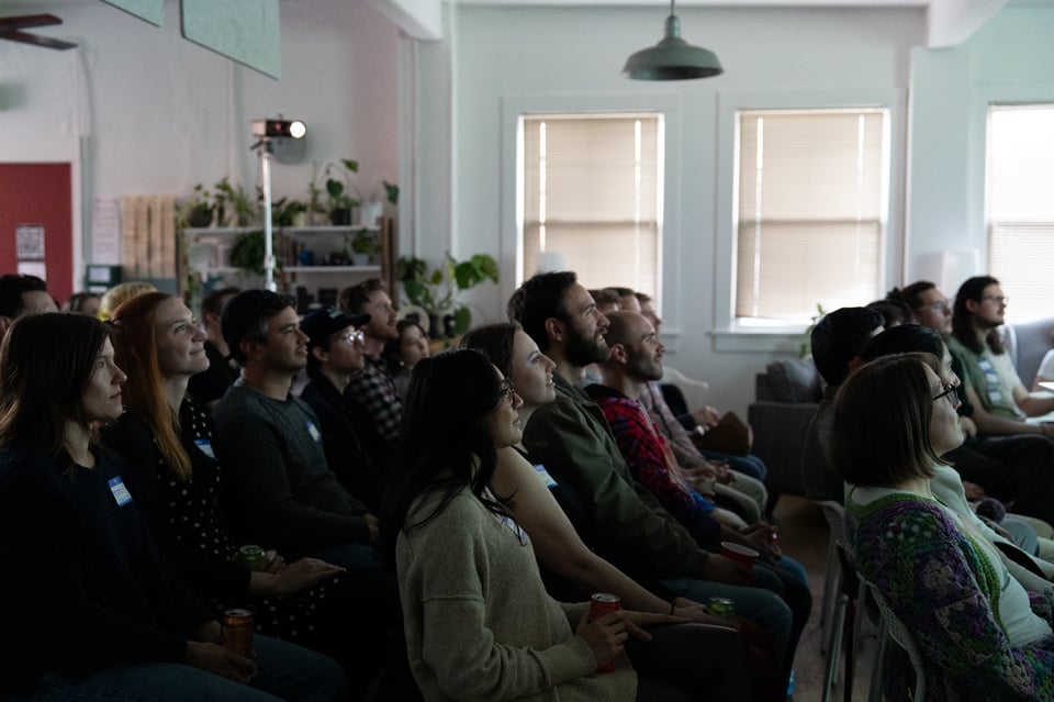 A crowd watching a presentation.