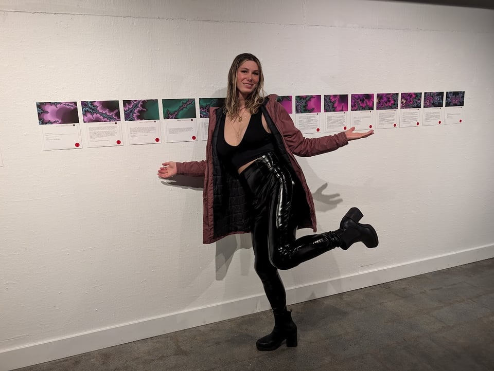 Me posing in front of the art exhibit, which consists of 14 images with accompanying text.