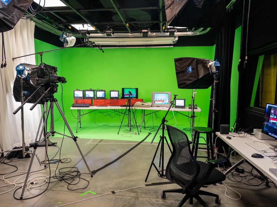 a green screen studio with analog video equipment set up in it
