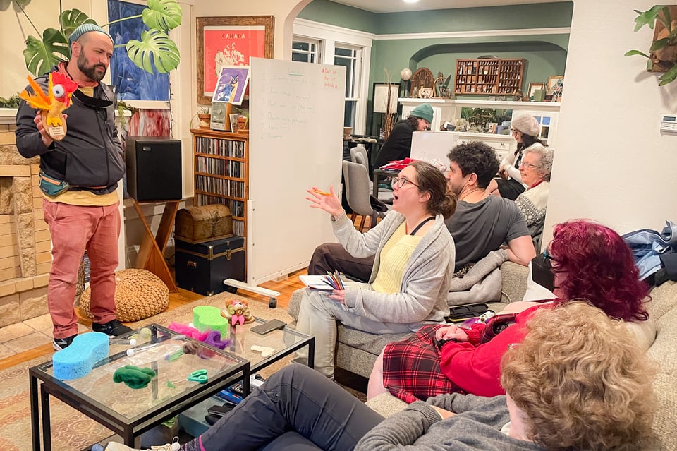a group of people in a living room enjoying the salon