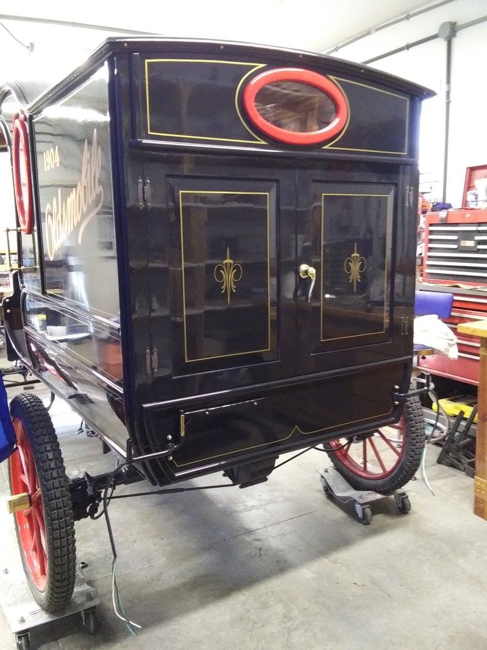 The back side of the vehicle featuring hinged doors with a brass handle