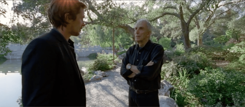 screen cap from the movie Knight of Cups, showing Christian Bale and Peter Matthiessen talking in a zen garden