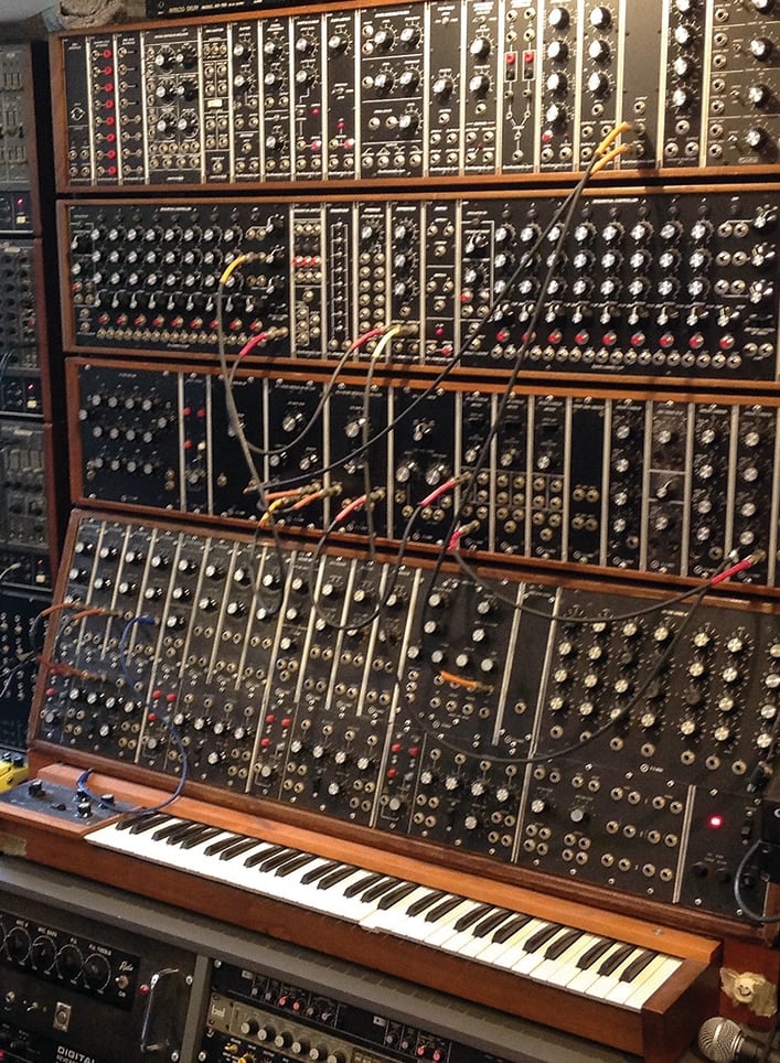 A wall of knobs, button switches, plugs and wires. Way too many to count. There is a keyboard at the bottom of the wall